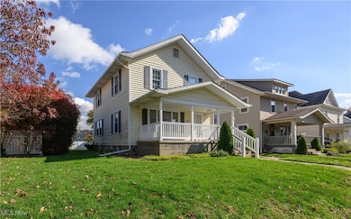 View of front of property featuring covered porch and a front lawn