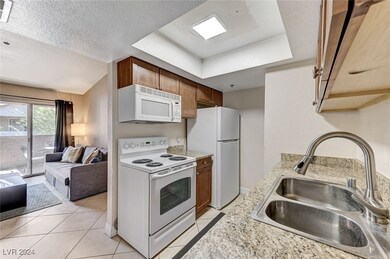 Kitchen with white appliances, open floor plan, li