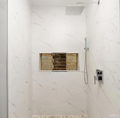Full bath featuring a marble finish shower