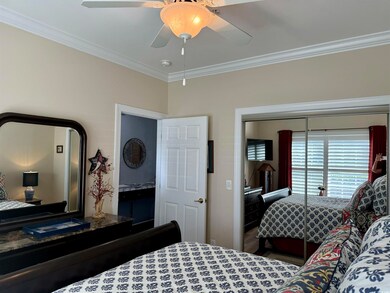Bedroom featuring a closet, ornamental molding, an