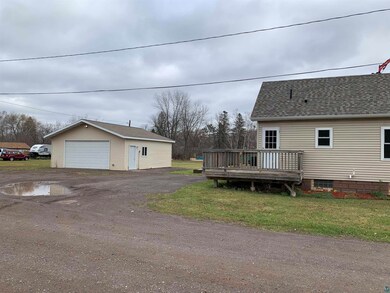 View of property exterior with a garage, a yard, a