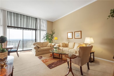 The wall of windows and a sliding door to the balc