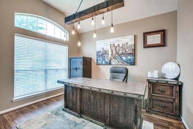 Laminate plank flooring and the beautiful light fixture make this a perfect office