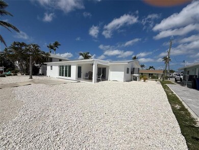 Rear view of property with stucco siding and open patio