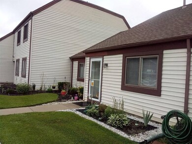 View of side of home featuring a yard
