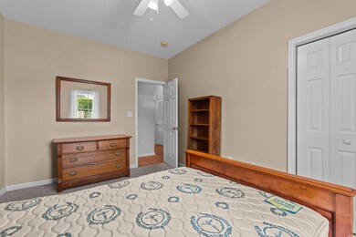 Bedroom featuring a closet, baseboards, ceiling fan, and carpet