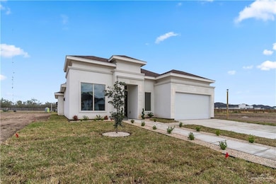 View of front facade with a garage and a front yard