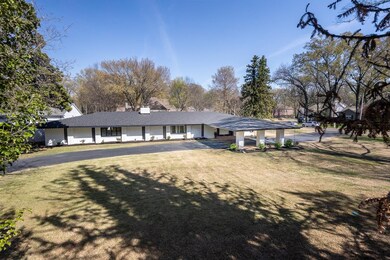 Ranch-style house with a chimney and a front yard