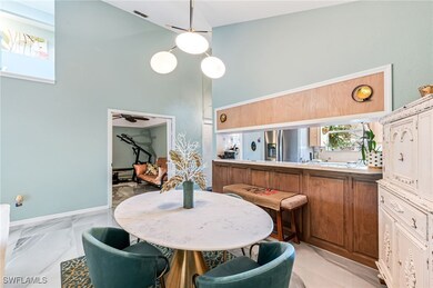 Dining area with a towering ceiling and ceiling fa