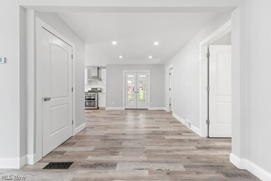 Unfurnished living room featuring light hardwood / wood-style floors and french doors