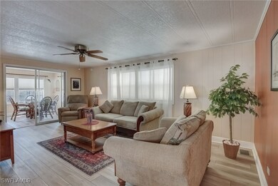 Living room with ceiling fan, a wealth of natural