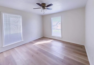 Unfurnished room with wood finished floors and ceiling fan