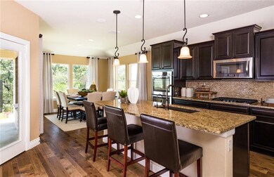 Spacious kitchen with pendant and recessed lightin
