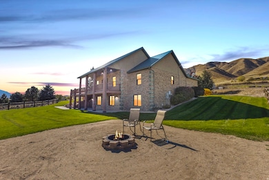 Valley facing side of house featuring a patio area, a balcony and an outdoor fire pit