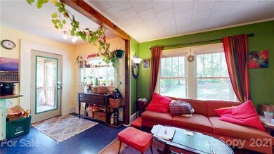 Dining room looking into kitchen and back porch