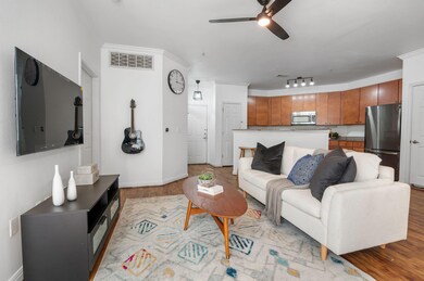 Living area with light wood-type flooring, a ceil