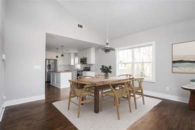Dining area featuring sink, high vaulted ceiling, 