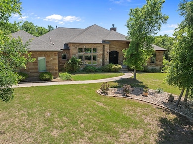 French country home with roof with shingles, ston