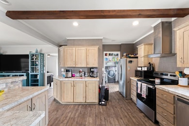 Kitchen with stainless steel appliances, light br