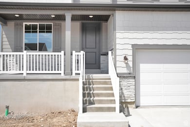 Property entrance featuring a porch, stone siding, and a garage