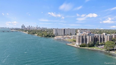 Aerial view of skyline, a large body of water, and a notable bridge