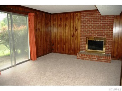 L shaped Family Room with brick fireplace & hearth