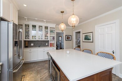 Kitchen featuring huge island with elegant white q
