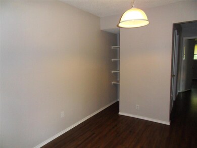 Empty room with dark wood-style flooring and base