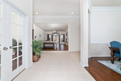 To the left as you enter is the dedicated study. French doors offer a buffer for sound to create a quiet workspace. To the right is the formal dining room. Note the beautiful floors and upgraded moldings!