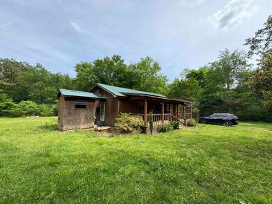 View of home's exterior featuring a porch, a lawn,