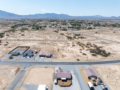 Aerial view of sparsely populated area featuring a mountain backdrop and nearby suburban area