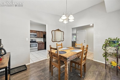 Dining space featuring a chandelier and wood finished floors
