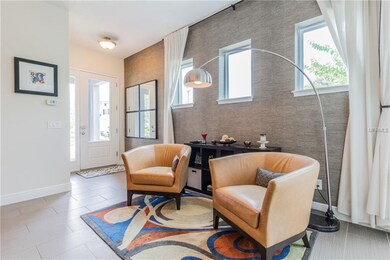 Living room and foyer with glass door and side lig