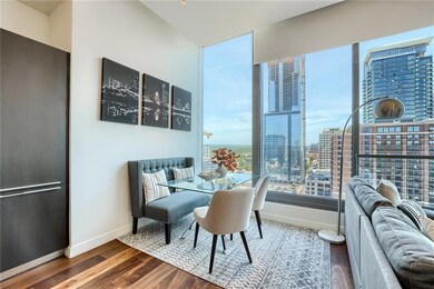 Dining room with baseboards, a city view, and woo