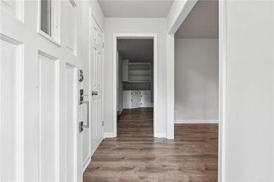 Hall featuring baseboards and wood finished floors