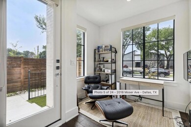 Living area with a healthy amount of sunlight and dark hardwood / wood-style flooring