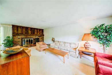 Large living with a handsome brick log burning fir