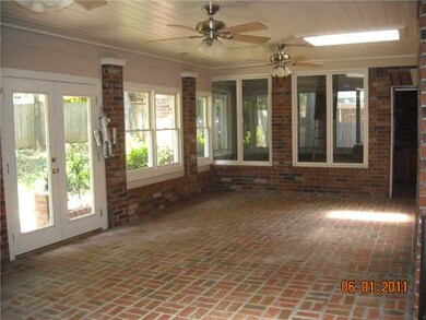 Enclosed brick patio with double hung/double pane 