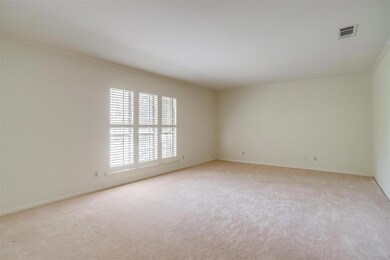 Carpeted empty room featuring ornamental molding