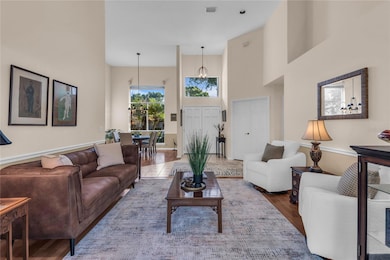 Living room with French doors leading to the spacious backyard, covered patio and spa