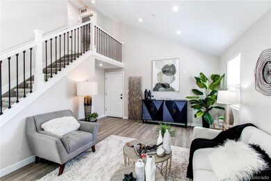 View of living room to frent door & upstairs with NEW iron railing.