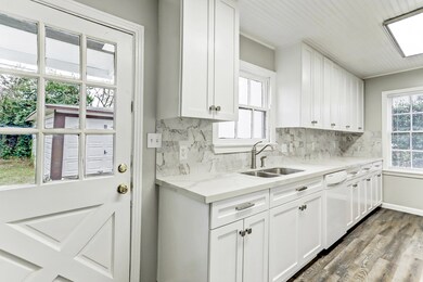 Remodeled Kitchen boasts marble counters & backspl