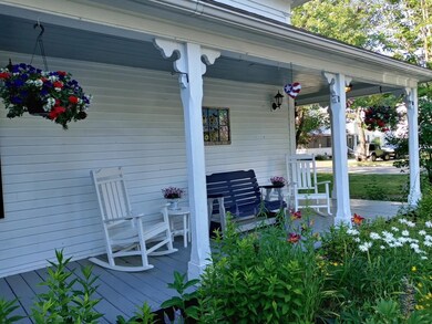 FLOWERS LINE THE BORDER OF THE OPEN PORCH IN THE SPRING, SUMMER AND FALL!
