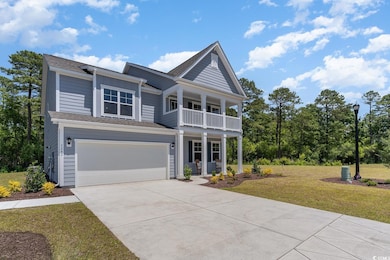 View of front of home with a front lawn, a porch, driveway, an attached garage, and board and batten siding