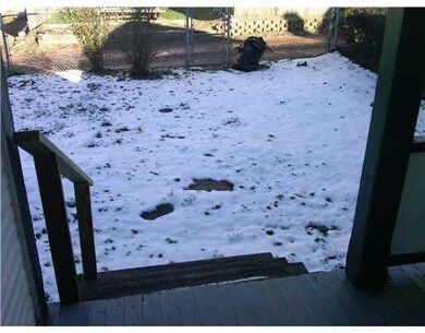 Exterior Back. Back porch leads to fenced yard