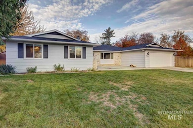 Ranch-style home with an attached garage, concrete driveway, and a patio