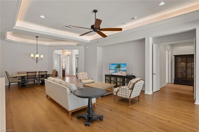 Living room featuring ceiling fan with notable cha