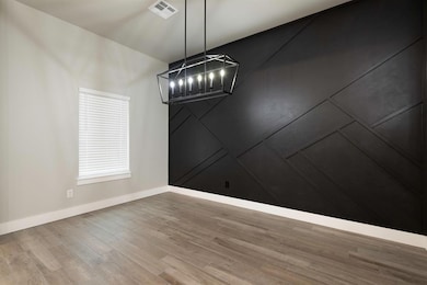Unfurnished dining area with an inviting chandelie