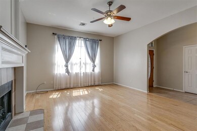 Unfurnished living room with a tile fireplace, ceiling fan, and light hardwood / wood-style flooring