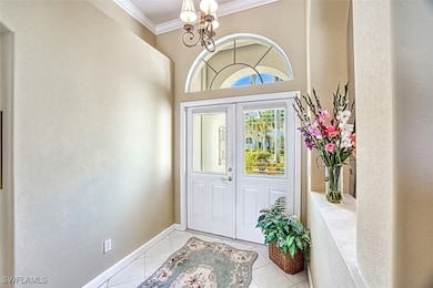 Tiled foyer entrance with an inviting chandelier a